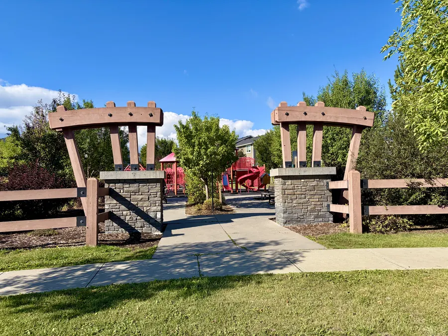 Timber archway and playground at Fireside Central Park, Cochrane, Alberta