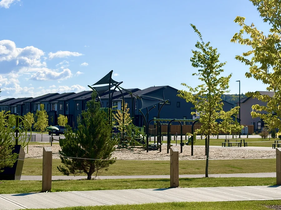 Townhomes and park shelter in Greystone, Cochrane, Alberta