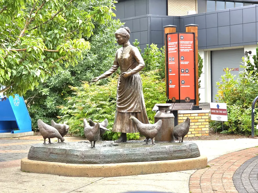 Bronze statue of a homesteader with chickens in downtown Cochrane, Alberta