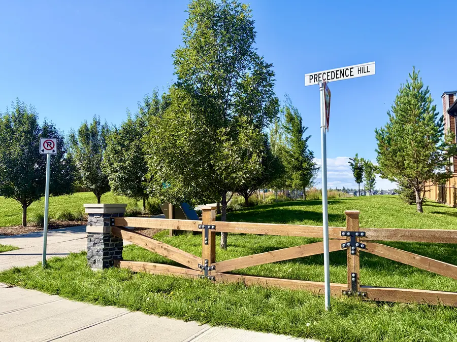 Green space and rail fencing at Precedence Hill in Riversong, Cochrane, Alberta